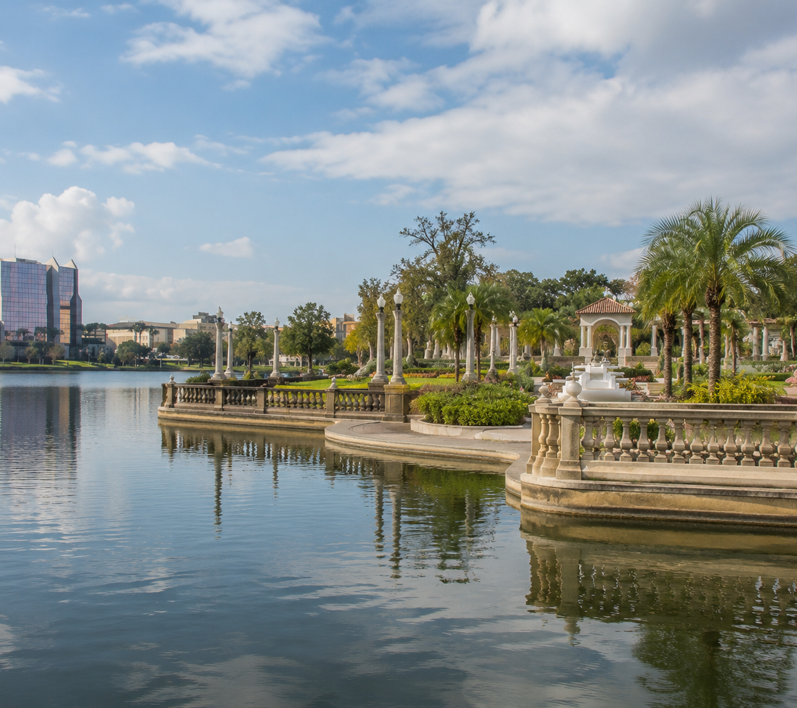 Paved promenade with a stone balustrade and ornamental urns, low towers on the far shore