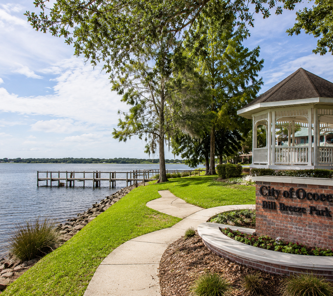 Gazebo on a landscaped point with a paved path, a pier and open water beyond